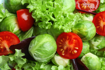 Tasty salad with Brussels sprouts as background, closeup