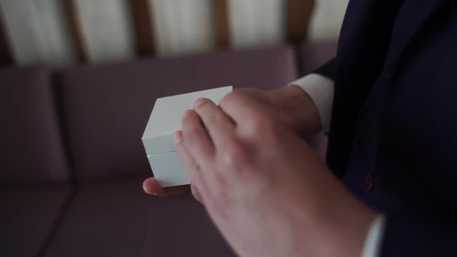 man holds a box with wedding rings