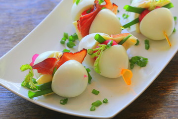 Keto diet. Hard boiled egg, radish , cheese and bacon sandwich on dark background. Easter recipe