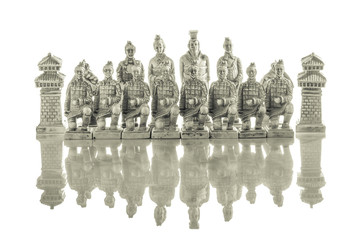 A view of several white chess pieces. Ceramic chess pieces against white color background