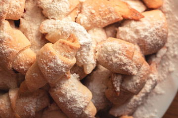 sweet homemade bagels, small in size, with jam sprinkled with icing sugar