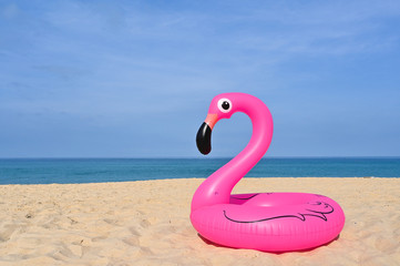 Flamingo shape, floating rubber ring by the beach