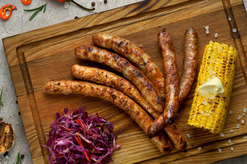 grilled sausages with coleslaw salad and corn