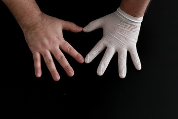 Two hands show heart shape on a black background
