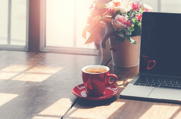 Startup working concept with laptop and cup of coffee on wooden table.