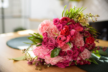 Modern white u-shaped kitchen in scandinavian style. Open shelves in the kitchen with plants and jars. Spring decoration spring flowers