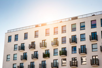 Fototapeta premium Modern apartment building flat estate concept. Outdoor residential facility at sunset and sunrise.