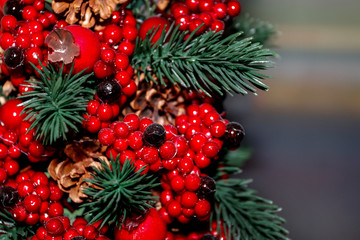 Fototapeta na wymiar Christmas background with red berries, cones and fir twigs.
