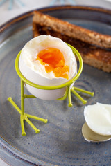 Delicious breakfast with soft boiled eggs and toasted bread.
