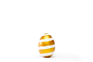 Minimal easter card. One easter trendy golden decorated egg on white background. Copy space for text.