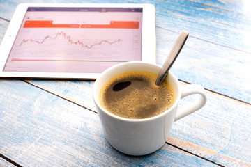 Hot black coffee with business on a blue painted wooden table