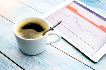 Hot black coffee with business on a blue painted wooden table