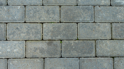 The texture of cement floor tiles. Rough surface with particles of sand and debris.