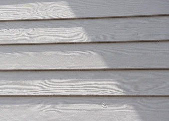 White wood texture with shadow in the afternoon.