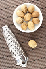 nutmeg seeds in a small white bowl