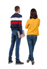 Back view couple with laptop in sweater.