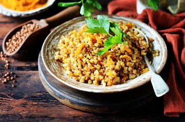 Buckwheat stew with vegetables in a ceramic bowl. rustic