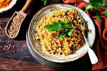 Buckwheat stew with vegetables in a ceramic bowl. rustic