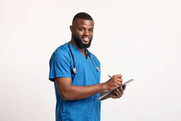Young african doctor working with patient anamnesis - obrazy, fototapety, plakaty