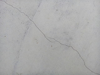 Crack of new concrete floor texture background. Broken concrete. Cracked concrete.