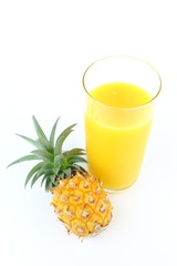fresh pineapple and a glass of pineapple juice isolated on a white background with copy space