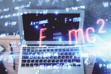 Desktop computer background and formula hologram writing. Double exposure. Education concept.