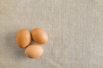 Top view of three bright painted easter eggs on canvas background. Colorful easter eggs decoration. Flat lay, top view. with copy space for text.