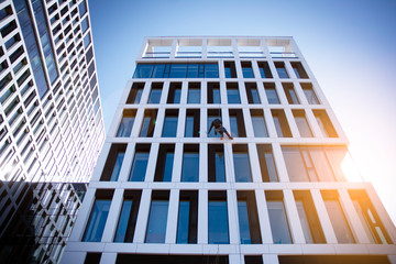 View of office building  with sunrise, reflection and perspective. Bright outlook for business. Modern office block with sunny beautiful sky.