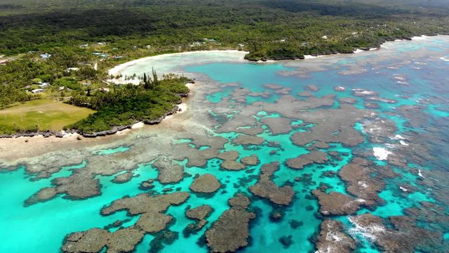 Aerial drone footage of Wadra Bay in Lifou New Caledonia.