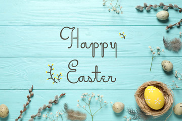 Flat lay composition with text Happy Easter and eggs on light blue wooden background