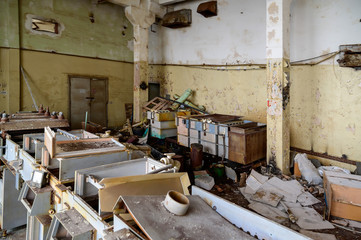 Photo of garbage indoors on the ruins of a slum plant