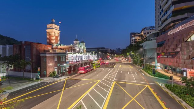 Street traffic near the fire station of Singapore night to day transition aerial timelapse. The Central Fire Station is the oldest existing fire station in Singapore on Hill street