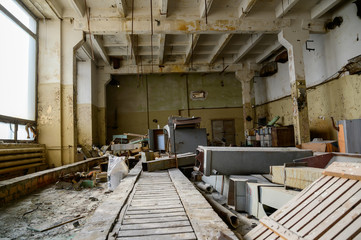 Photo of garbage indoors on the ruins of a slum plant