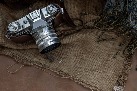 Top view of A Vintage photo camera on Sack cloth background.