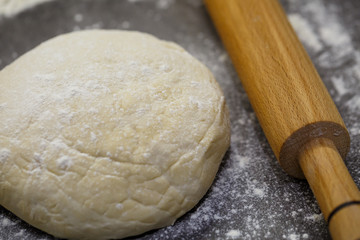 flour dough for baking cookies on the kitchen table