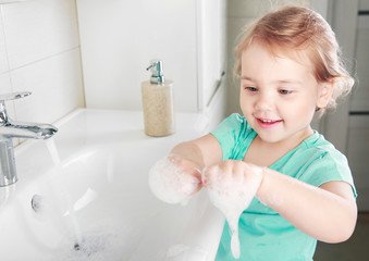 Child washing hands with soap,kid's hygiene concept.