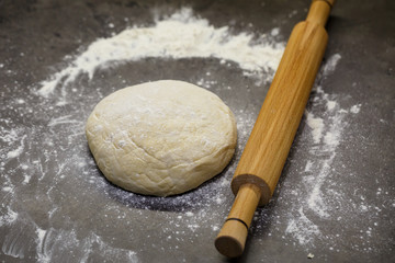 flour dough for baking cookies on the kitchen table
