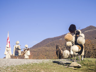 Regional georgian costumes and hats in local market.