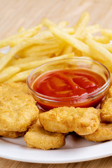 Delicious Chicken nuggets and french fries with ketchup