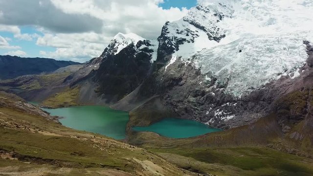Aerial, reverse, drone shot of Ausangate mountain and the double lakes, in the Andes, Peru, South America