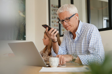 senior man working on his computer at home