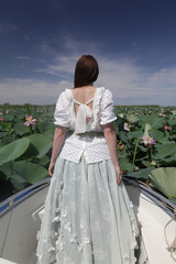 Tourist fashion girl and beautiful pink flowers of Caspian lotus (elumbo nucifera, indian lotus,...