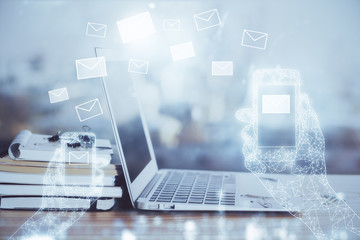 Desktop computer background in office and flying envelops hologram drawing. Multi exposure. Electronic mail concept.