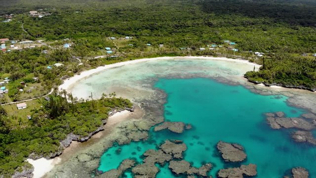 Aerial drone footage of Wadra Bay in Lifou New Caledonia.