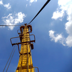 Cargo arrow harbor crane against the sky.