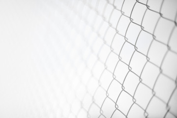 Close up rusty wire fence and blurred nature background. Wire netting or metal fence net and out of...