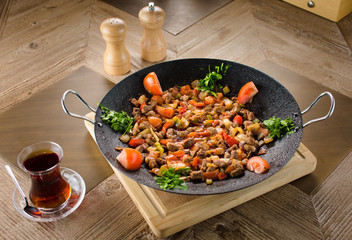 Stir fry meat with vegetable served and french fries