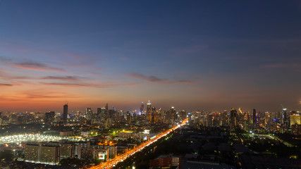 Fototapeta na wymiar Panorama of cityscape with sunset over the building and blue sky at bangkok ,Thailand. View of the tall building in capital with twilight .Shot using Panorama technique.