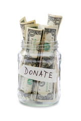 glass jar for donations filled with one dollar banknotes isolated on white background