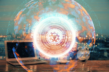 Computer on desktop in office with technology theme hologram. Multi exposure. Tech concept.